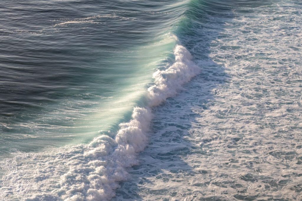Stunning capture of powerful ocean waves crashing on the Bali coast, showcasing nature's beauty.